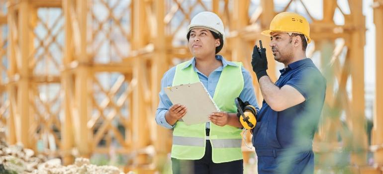 A man and a woman in a construction site.