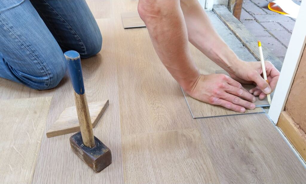 A person holding a pencil while working on a project.